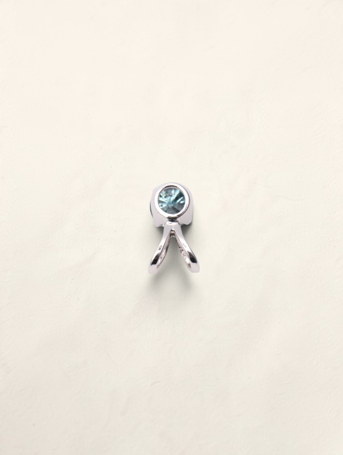 Zafrah 14k white gold solitaire pendant featuring a round blue diamond in a polished bezel setting.